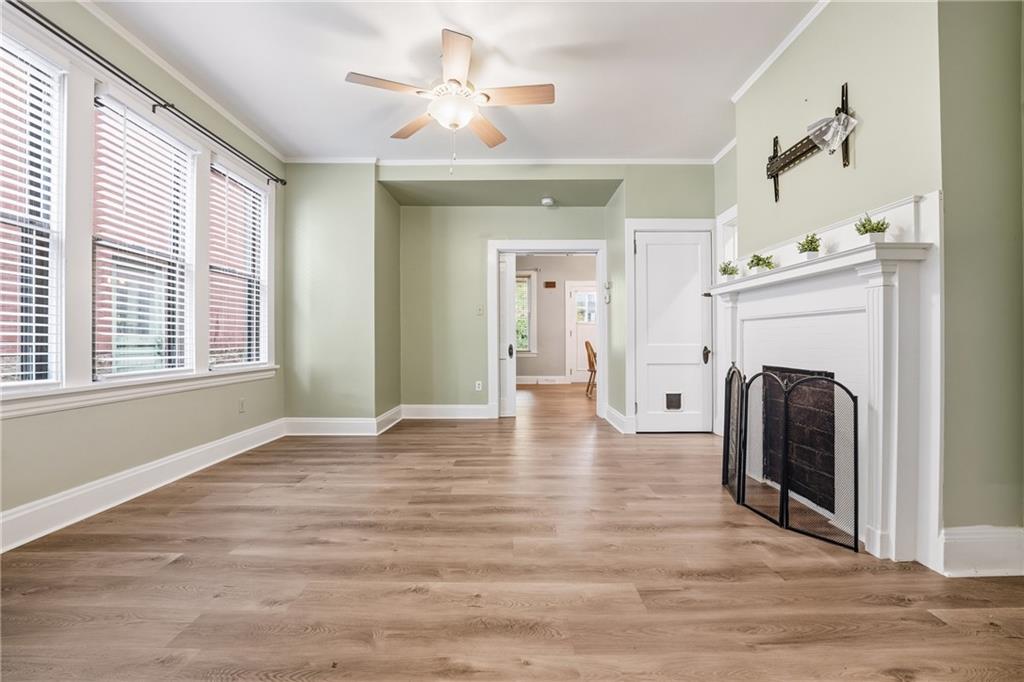 233 South Starr Avenue Pittsburgh, PA 15202 - Photo 17 of 43 a view of a livingroom with a fireplace a ceiling fan and wooden floor