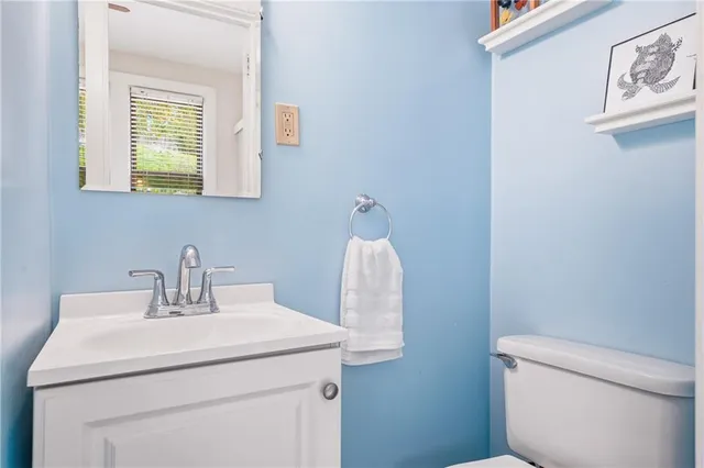 a bathroom with a sink a toilet and mirror