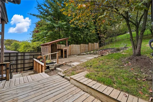 a view of balcony with wooden floor and fence