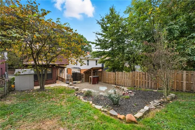 a view of a house with a yard and sitting area