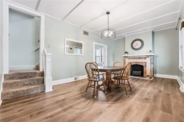 a view of a livingroom with furniture a fireplace and chandelier
