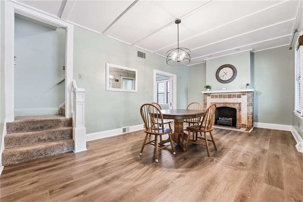 233 South Starr Avenue Pittsburgh, PA 15202 - Photo 8 of 43 a view of a livingroom with furniture a fireplace and chandelier