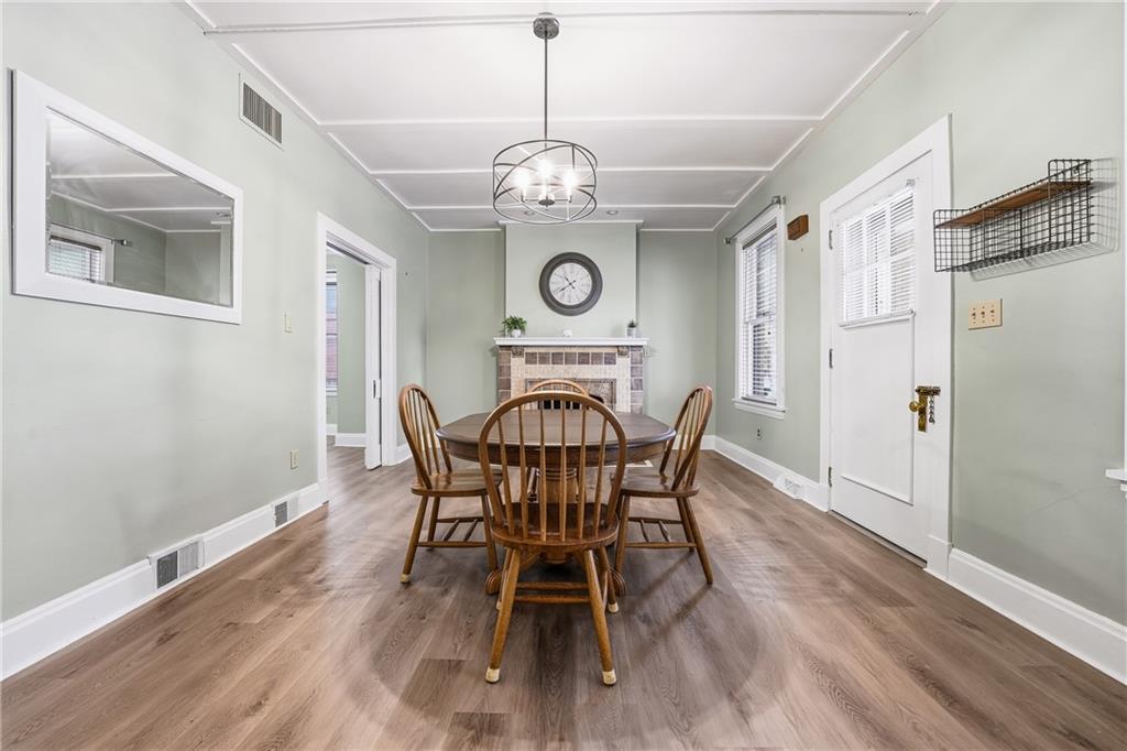 233 South Starr Avenue Pittsburgh, PA 15202 - Photo 9 of 43 a view of a dining room with furniture a chandelier and wooden floor
