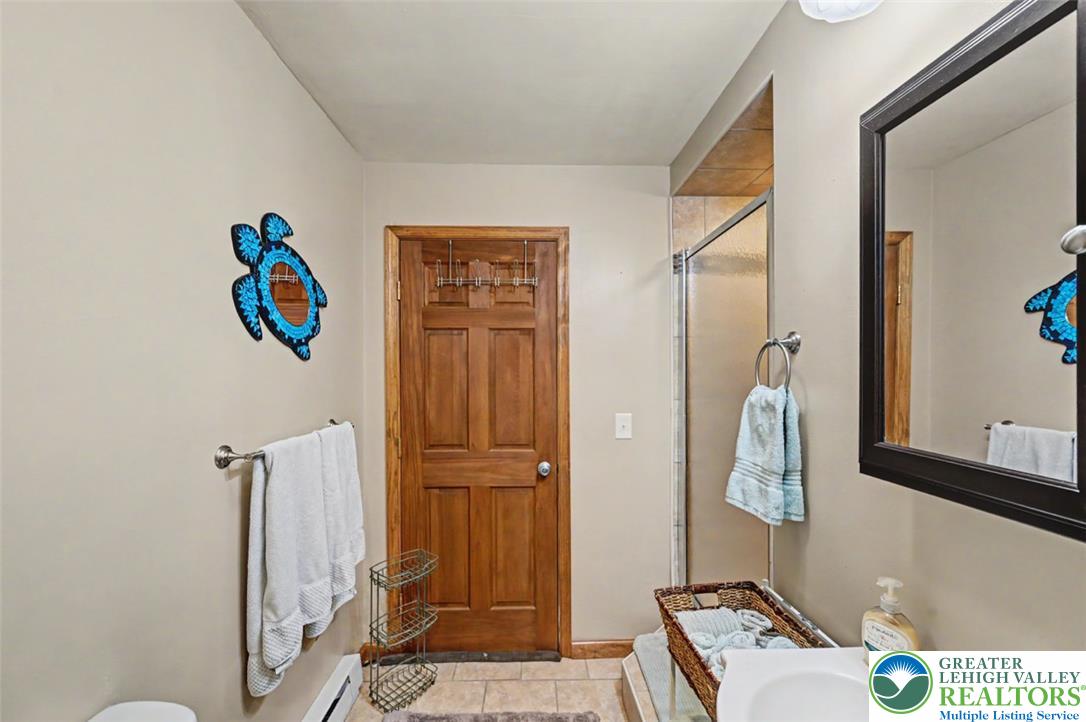 386 Upper Rdg Drive Effort, PA 18330 - Photo 35 of 56 A compact bathroom offers essential functionality with a simple vanity and a convenient shower.