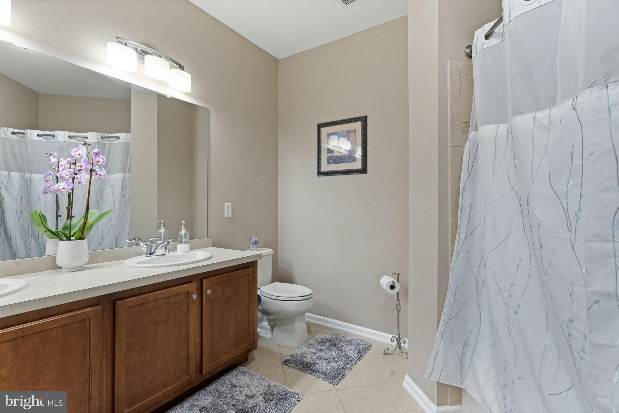 218 Timberlake Drive Ewing, NJ 08618 - Photo 17 of 30 a bathroom with a double vanity sink toilet and a mirror