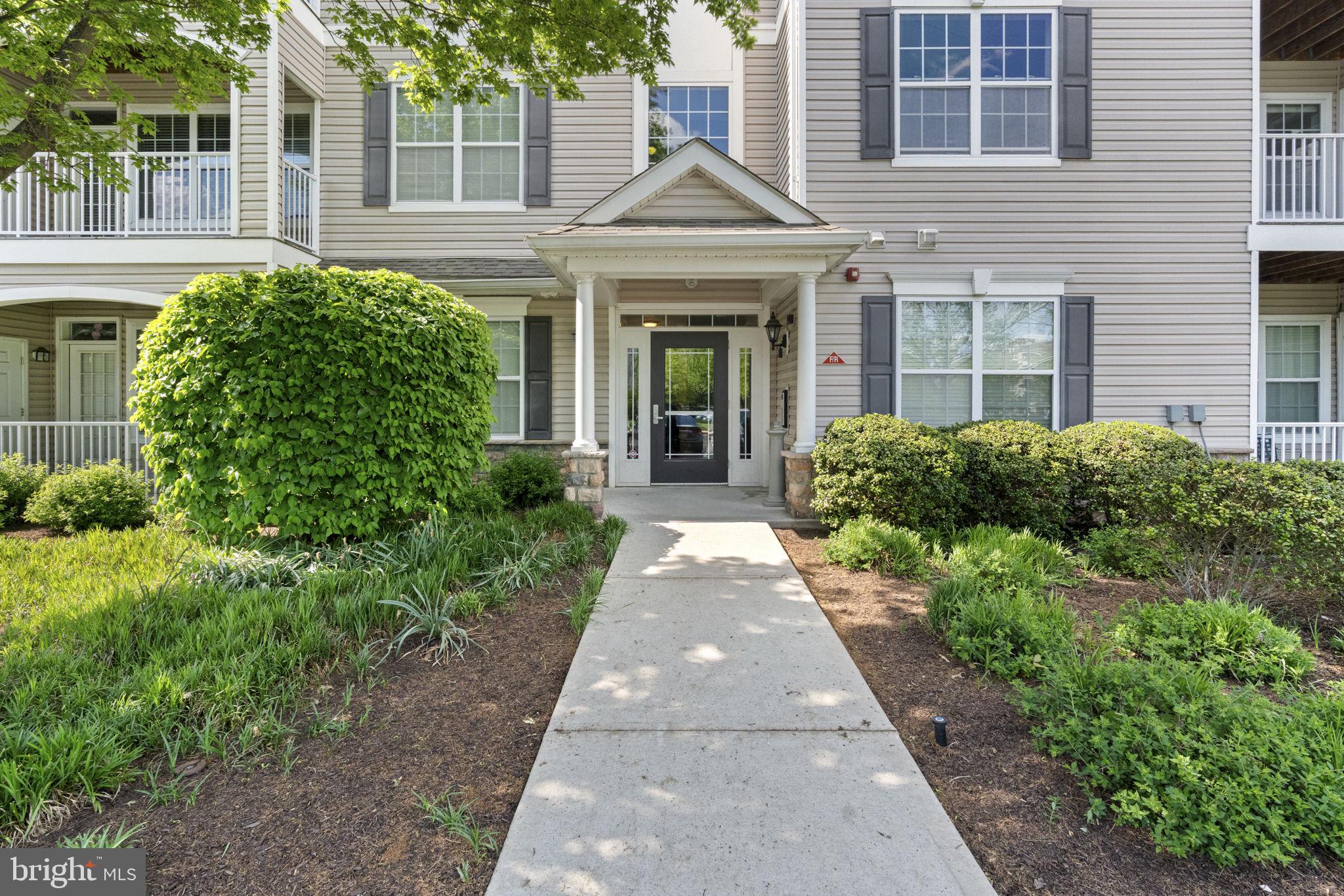 218 Timberlake Drive Ewing, NJ 08618 - Photo 2 of 30 front view of a brick house with a large windows