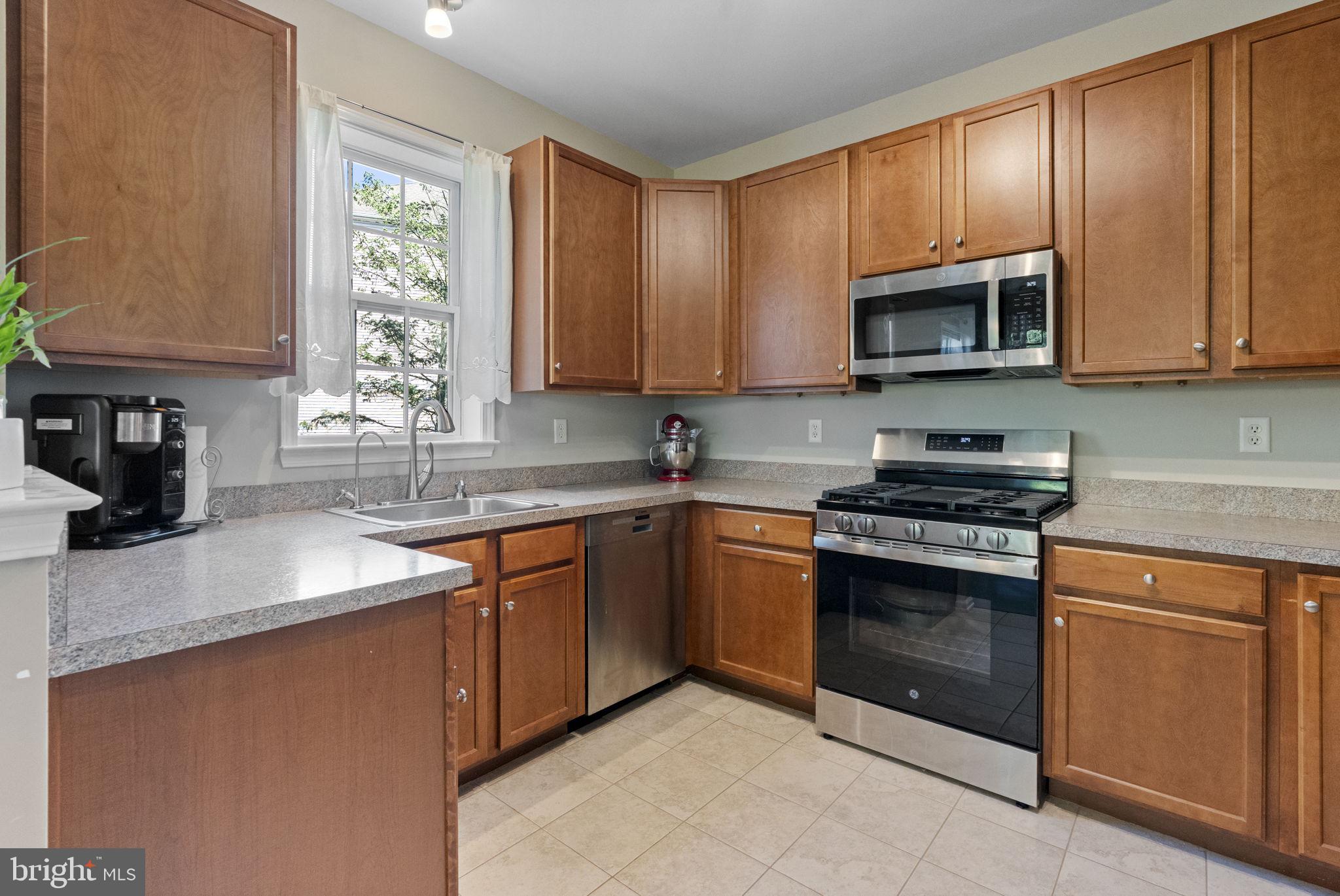 218 Timberlake Drive Ewing, NJ 08618 - Photo 8 of 30 a kitchen with stainless steel appliances granite countertop a sink stove and microwave