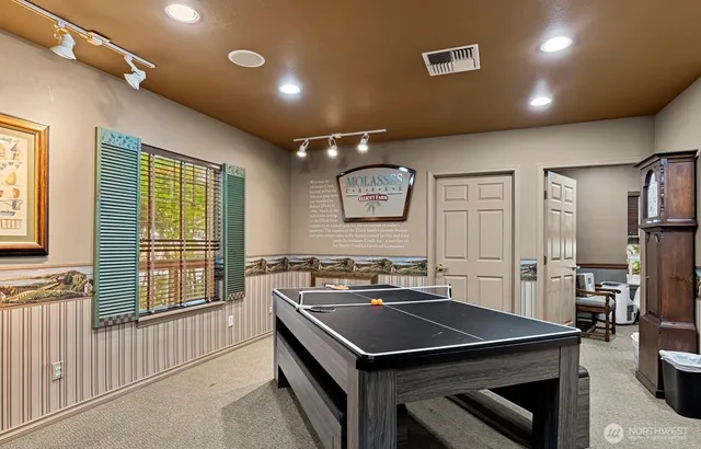 a kitchen that has a stove a sink dishwasher and a refrigerator with wooden floor