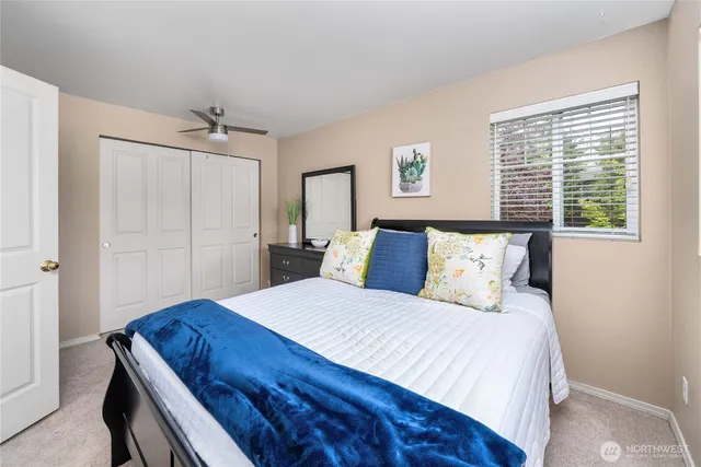 a bedroom with a bed and a window