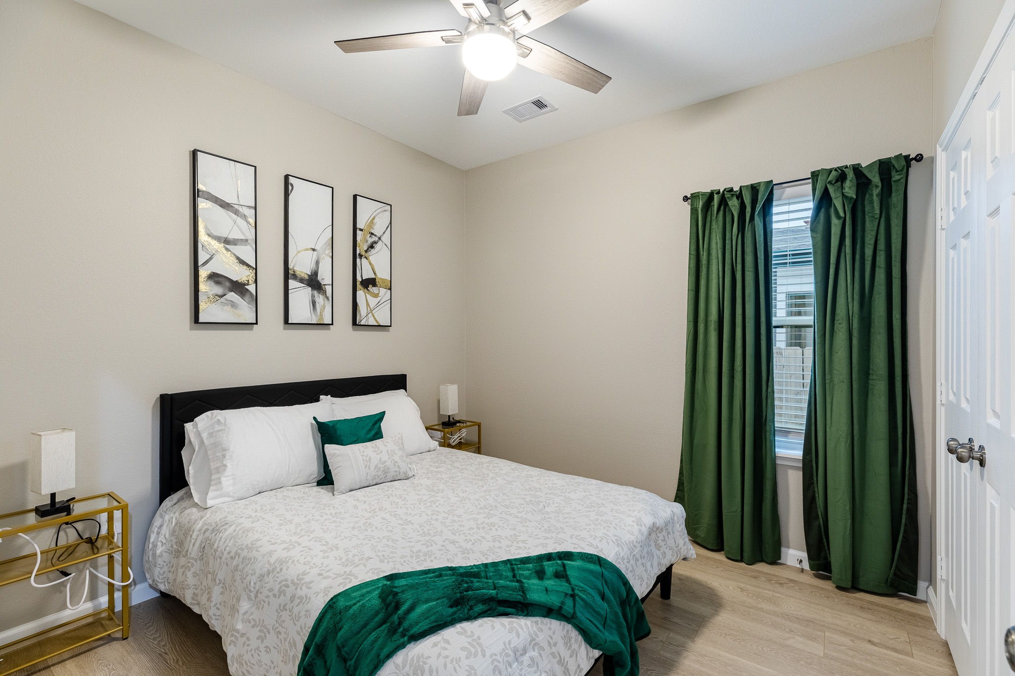 4661 Clover Street, Unit B Houston, TX 77051 - Photo 11 of 26 a bedroom with a large bed and a chandelier