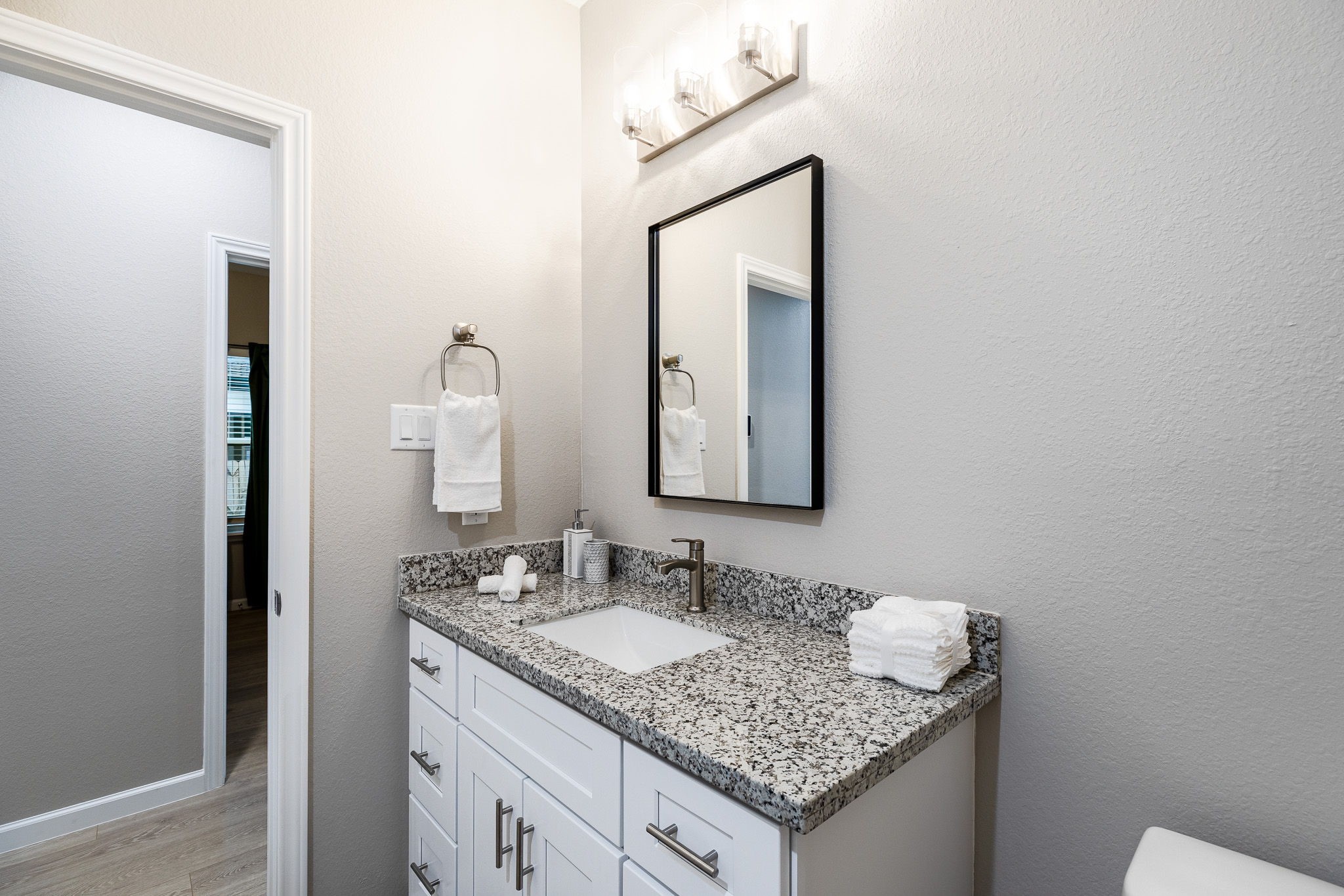 4661 Clover Street, Unit B Houston, TX 77051 - Photo 15 of 26 a bathroom with a granite countertop sink and a mirror