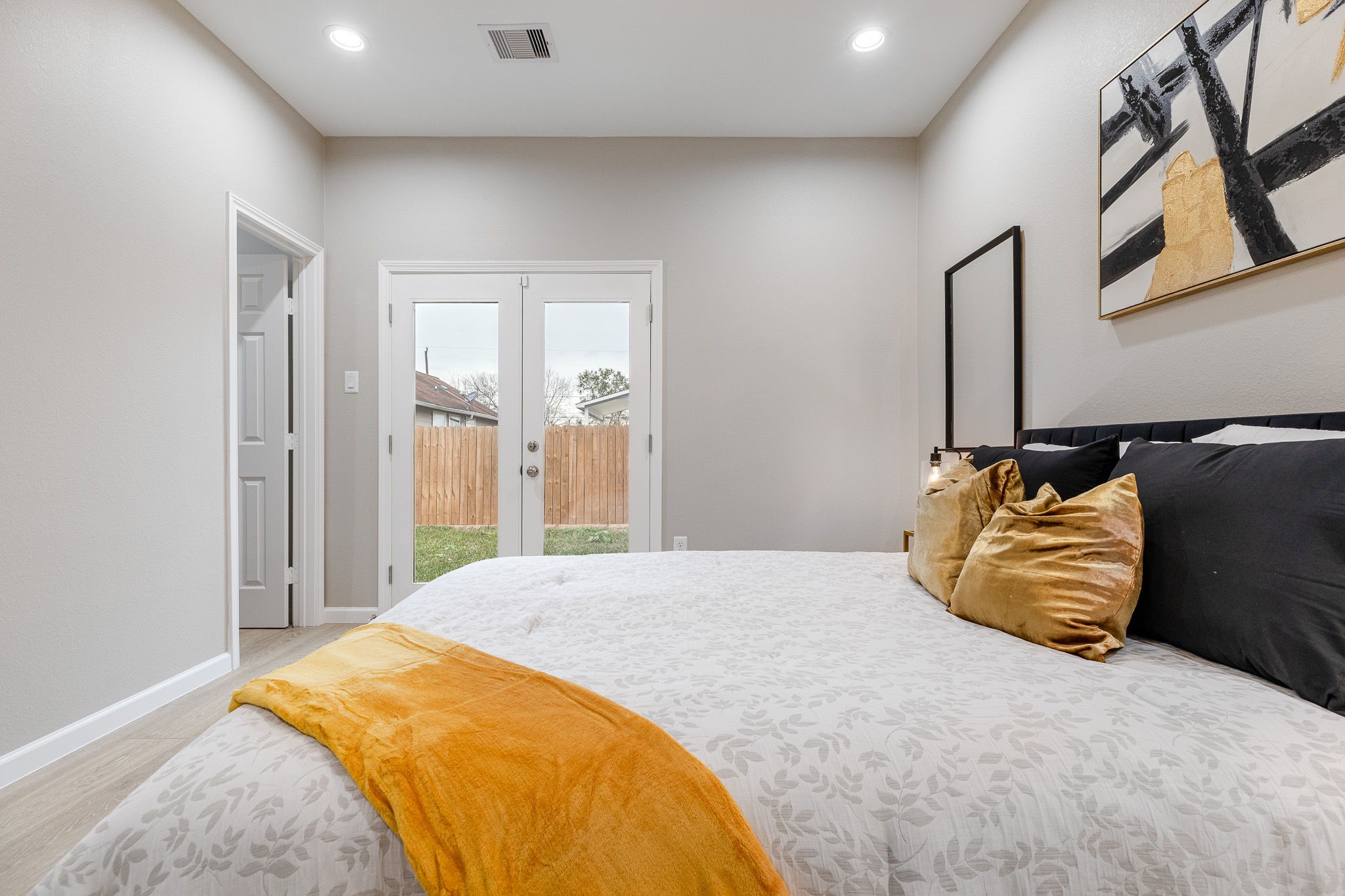 4661 Clover Street, Unit B Houston, TX 77051 - Photo 20 of 26 a bedroom with a bed and wooden floor
