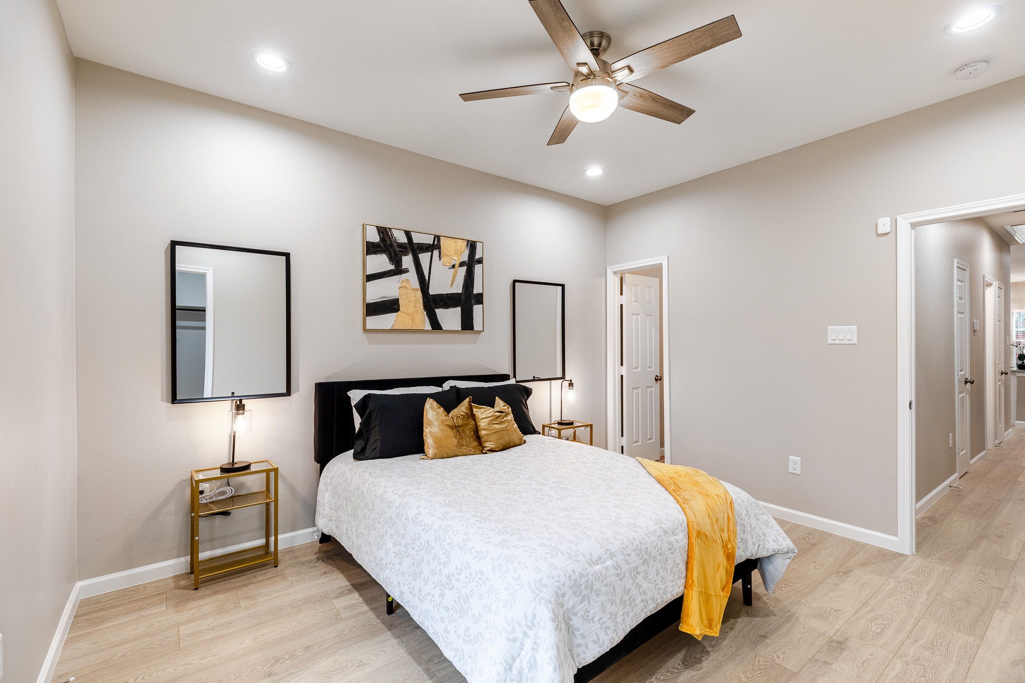 4661 Clover Street, Unit B Houston, TX 77051 - Photo 22 of 26 a bedroom with a large bed and a ceiling fan