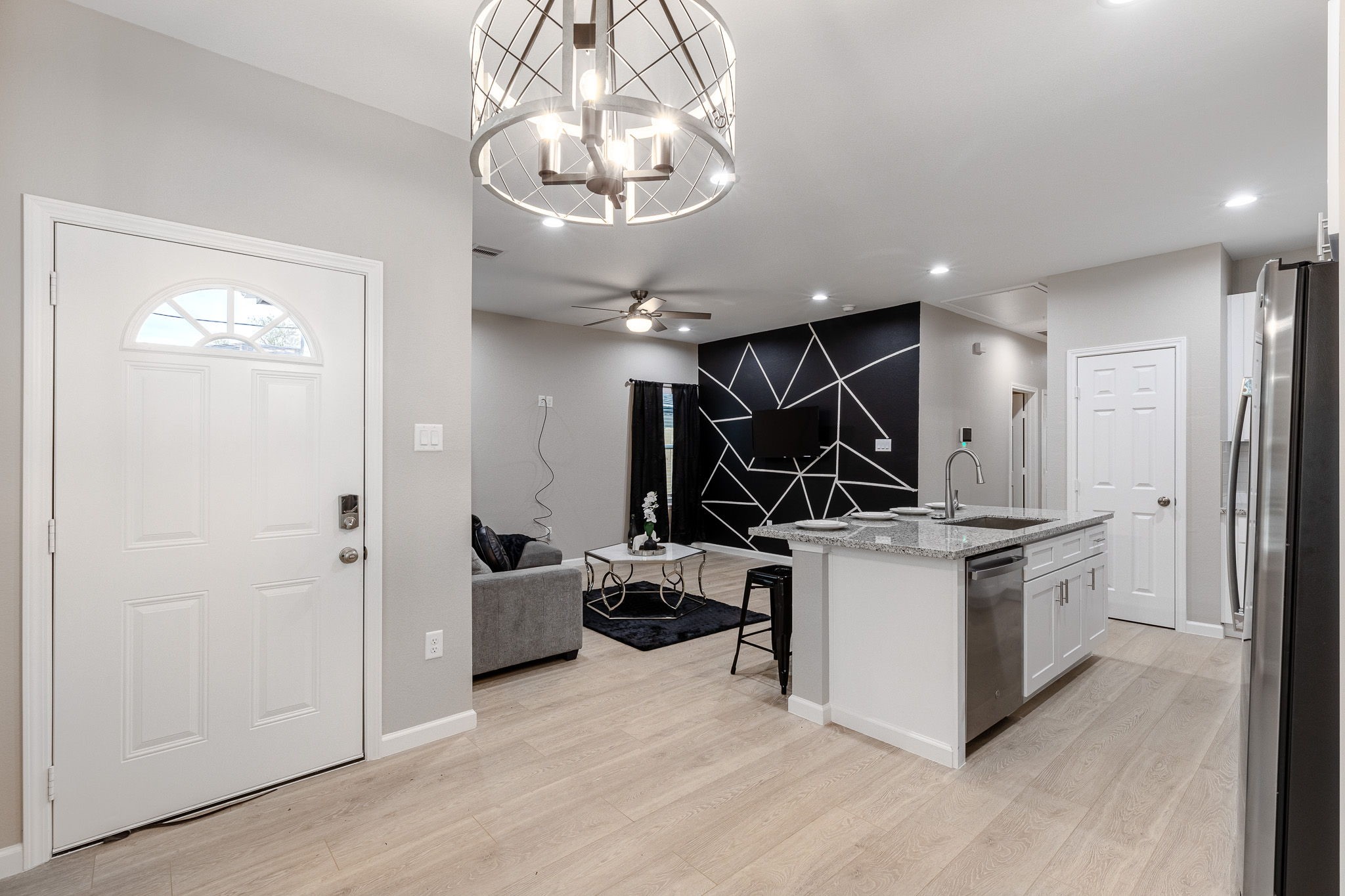 4661 Clover Street, Unit B Houston, TX 77051 - Photo 3 of 26 a kitchen with a sink stainless steel appliances a chandelier