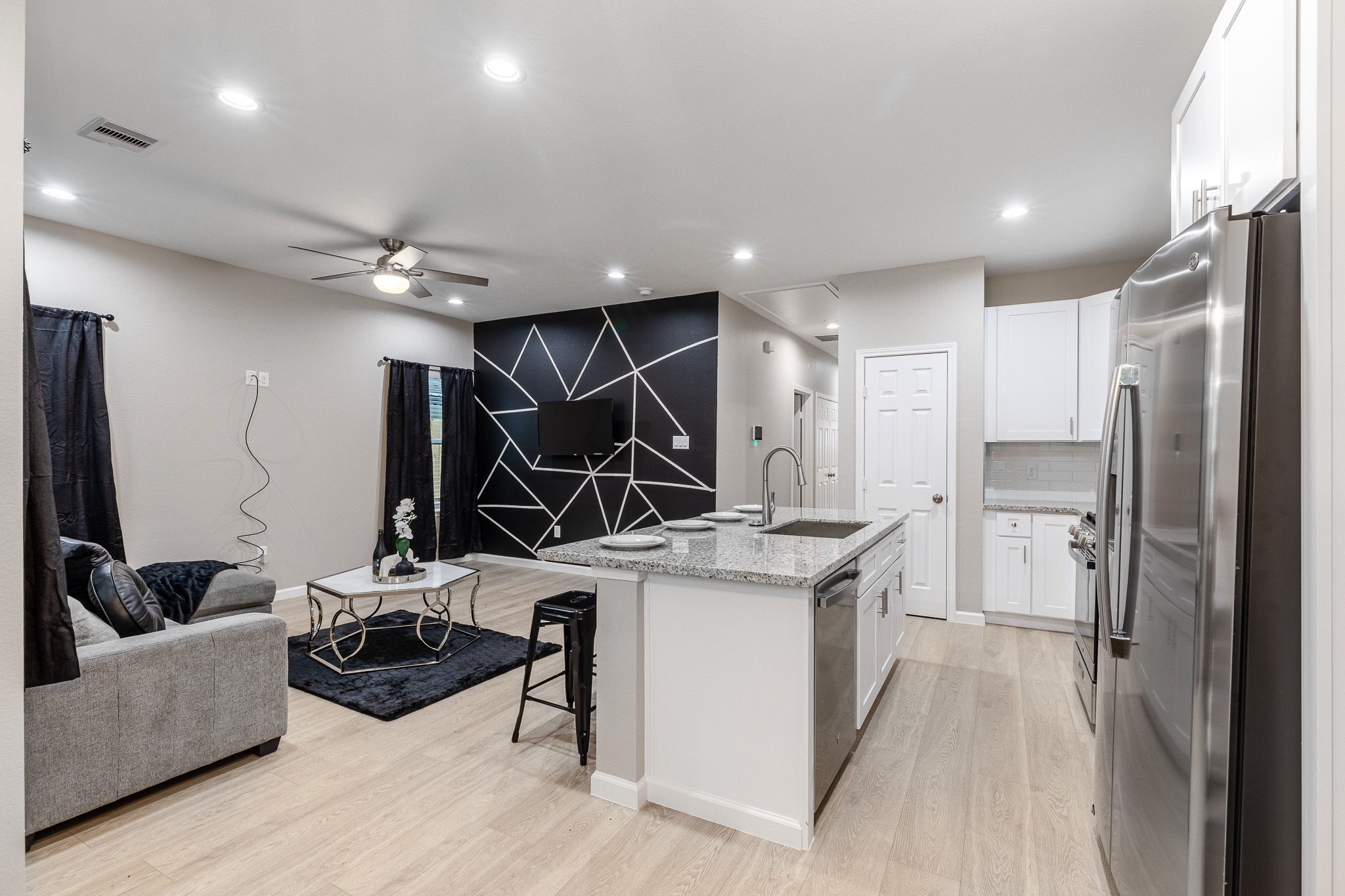 4661 Clover Street, Unit B Houston, TX 77051 - Photo 4 of 26 a kitchen with stainless steel appliances kitchen island a stove a refrigerator and a sink