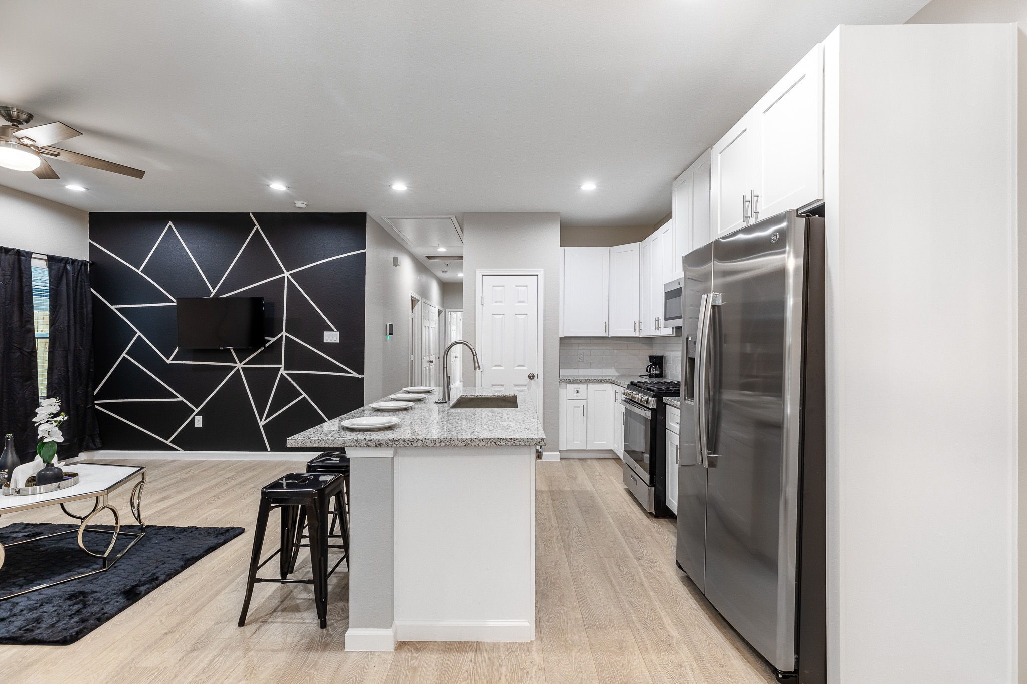 4661 Clover Street, Unit B Houston, TX 77051 - Photo 6 of 26 a kitchen with kitchen island a counter top space cabinets and stainless steel appliances