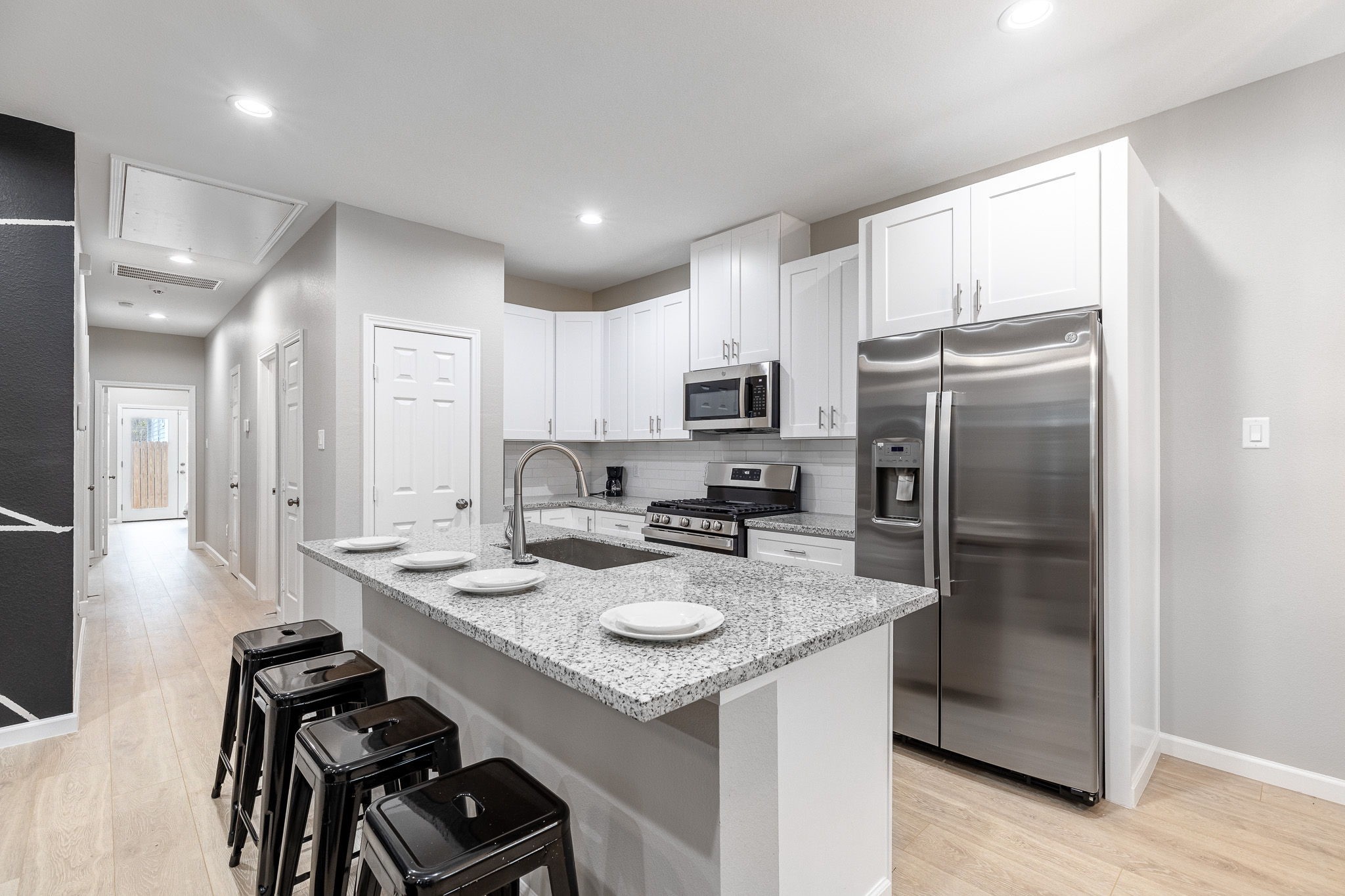 4661 Clover Street, Unit B Houston, TX 77051 - Photo 7 of 26 a kitchen with stainless steel appliances granite countertop a sink stove refrigerator and cabinets