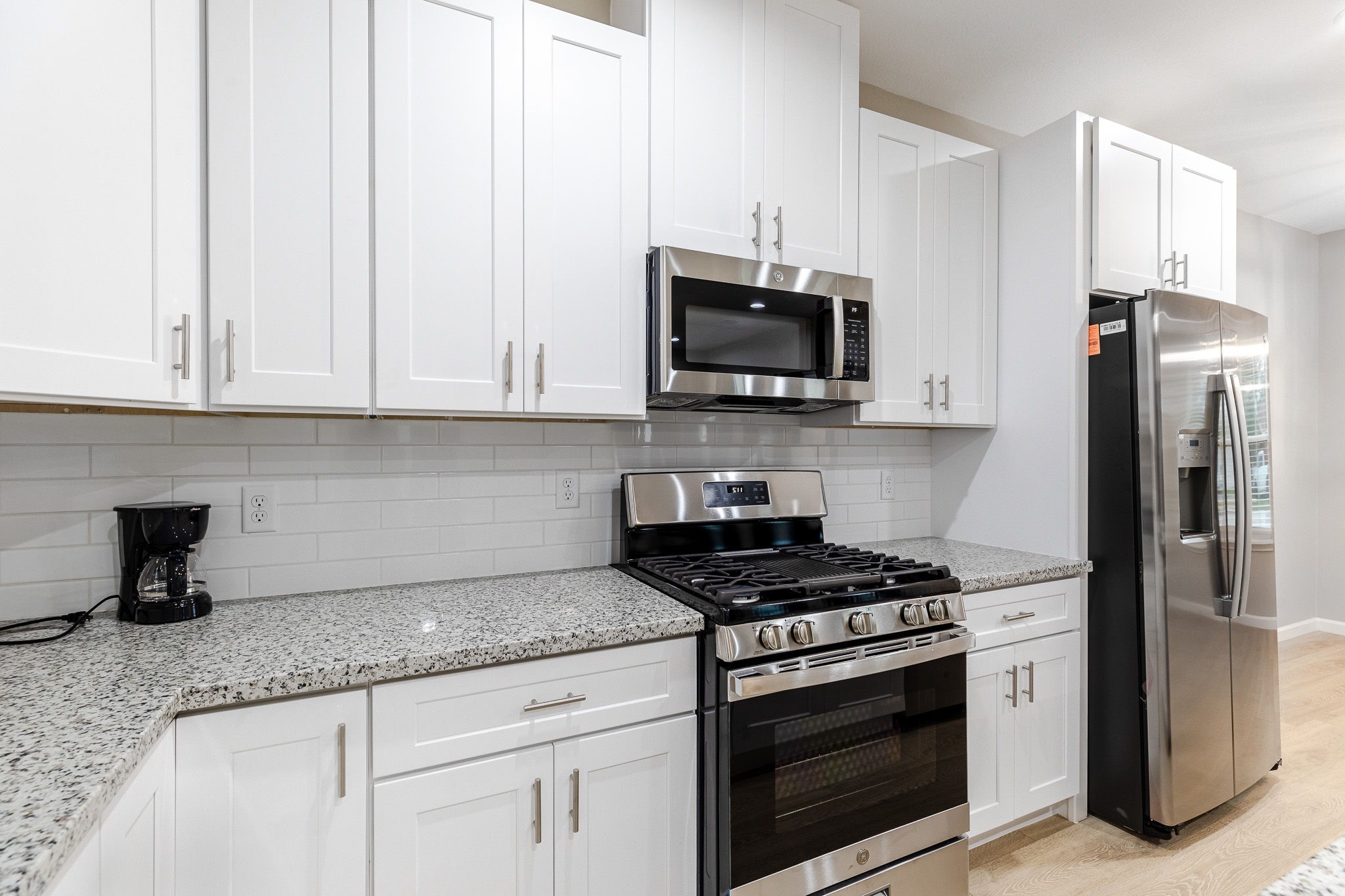 4661 Clover Street, Unit B Houston, TX 77051 - Photo 8 of 26 a kitchen with granite countertop a sink stove and microwave