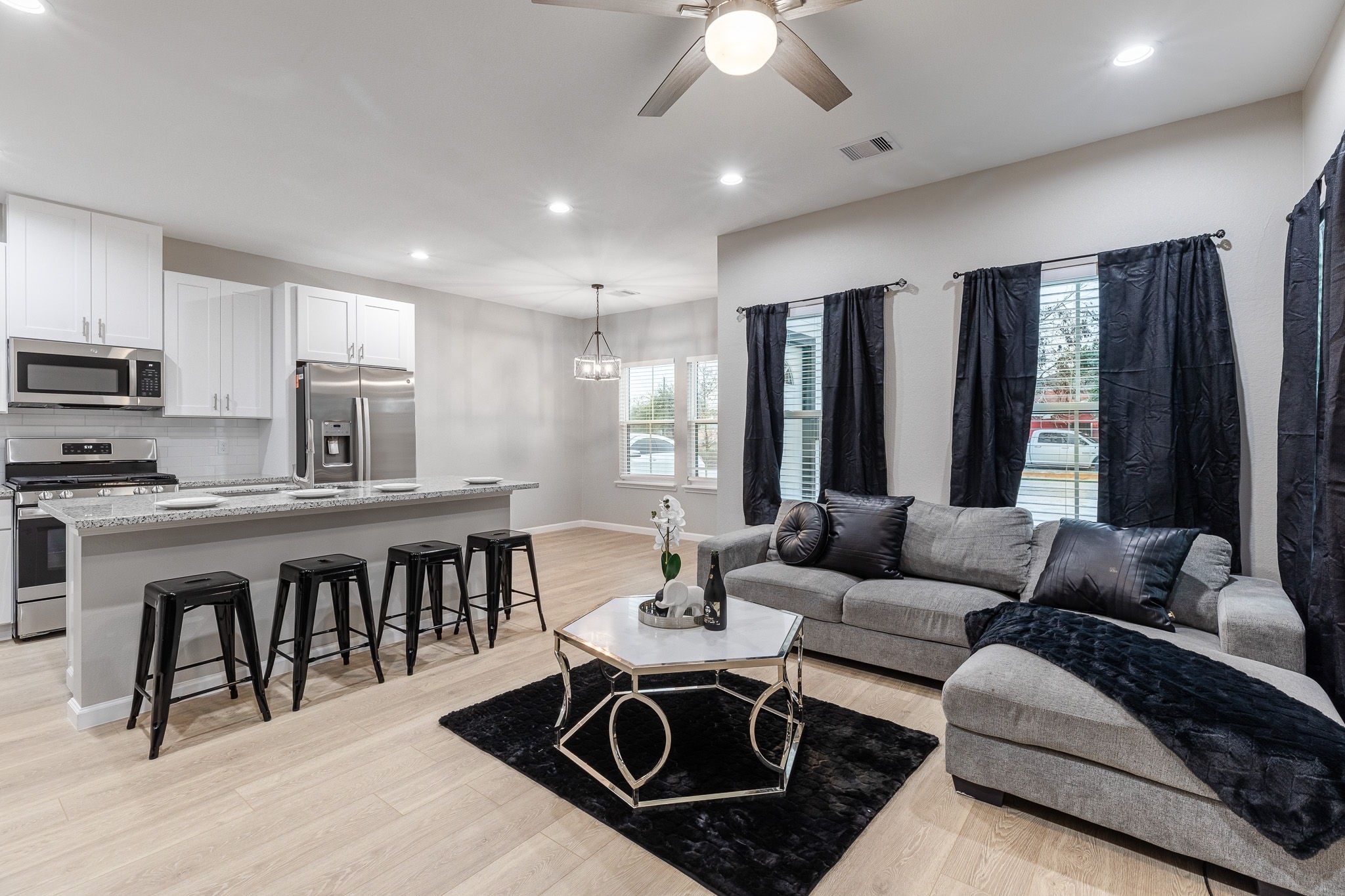 4661 Clover Street, Unit B Houston, TX 77051 - Photo 10 of 26 a open kitchen with stainless steel appliances granite countertop a stove a sink a dining table and chairs with wooden floor