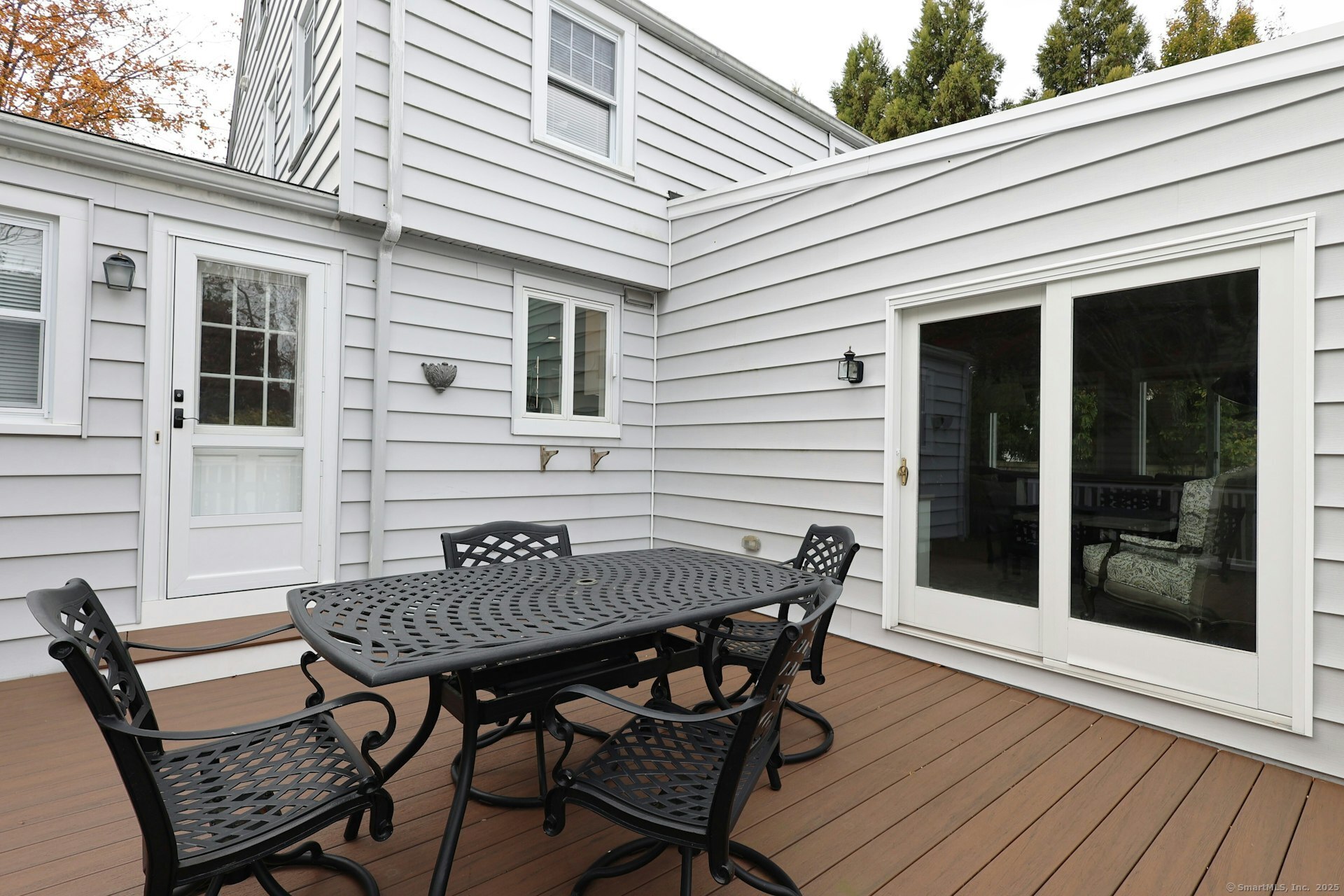 100 Overhill Road Fairfield, CT 06824 - Photo 23 of 40 a view of a patio with table and chairs and wooden floor