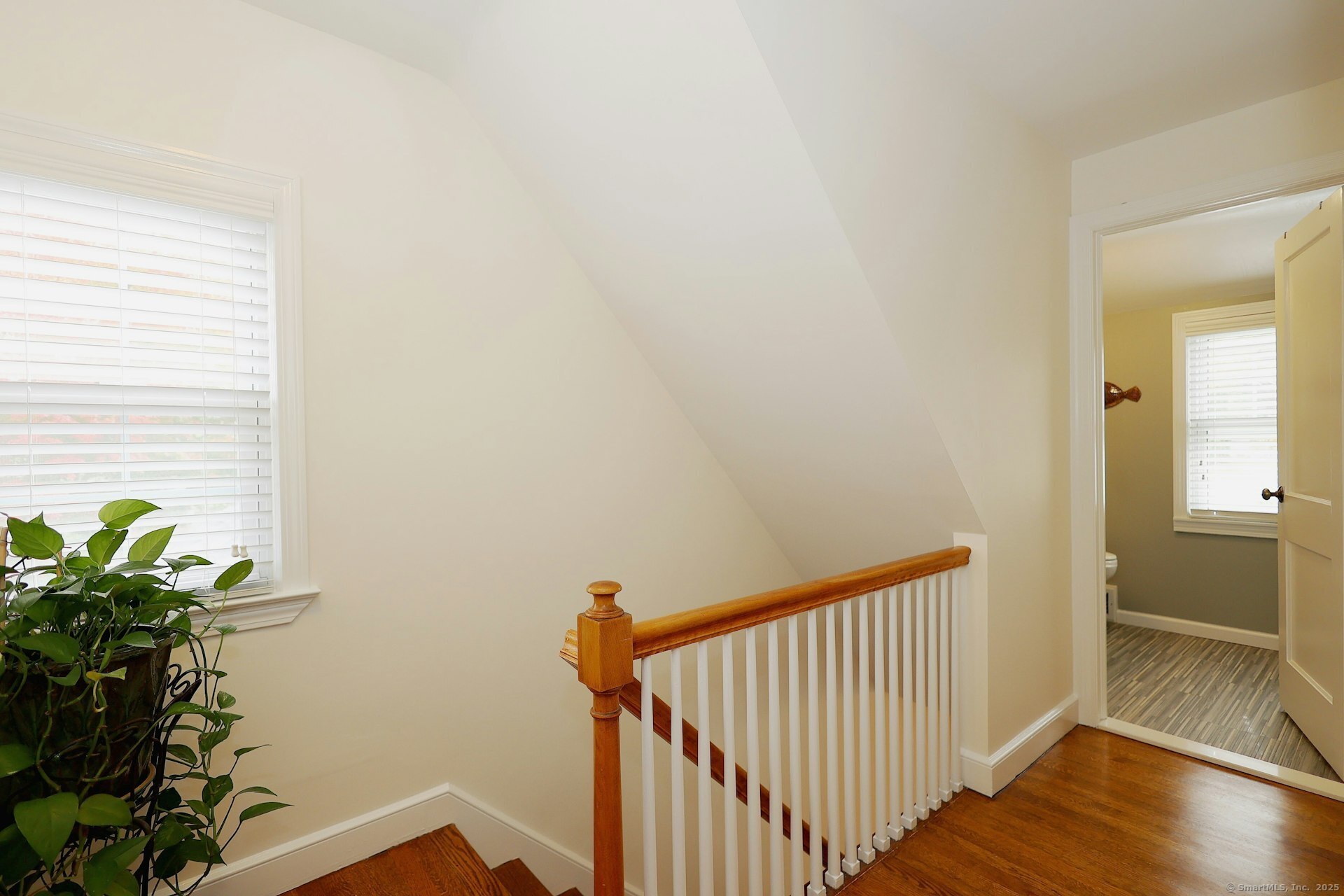 100 Overhill Road Fairfield, CT 06824 - Photo 25 of 40 a view of a hallway with wooden floor and a potted plant