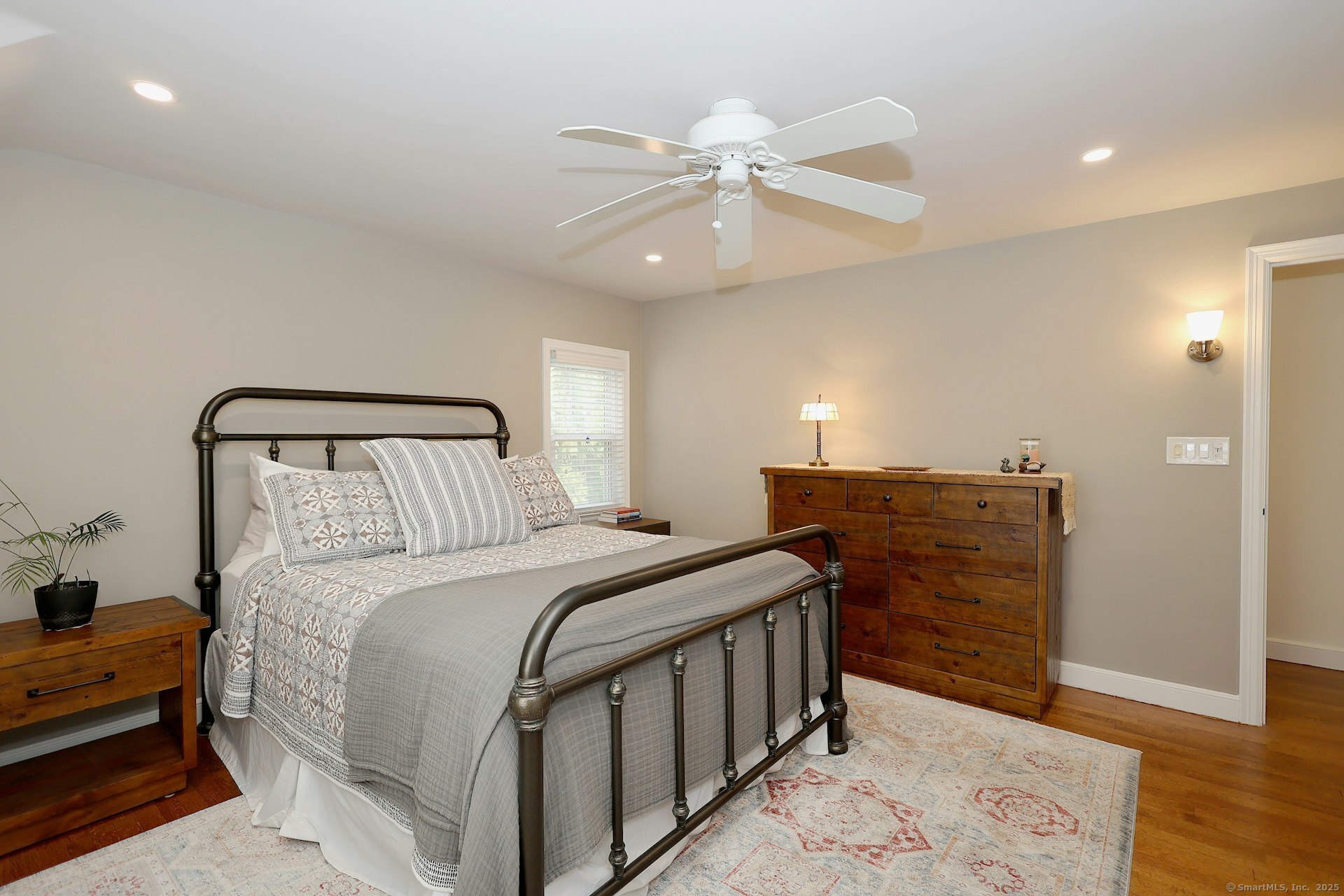 100 Overhill Road Fairfield, CT 06824 - Photo 27 of 40 a bedroom with a bed and wooden floor