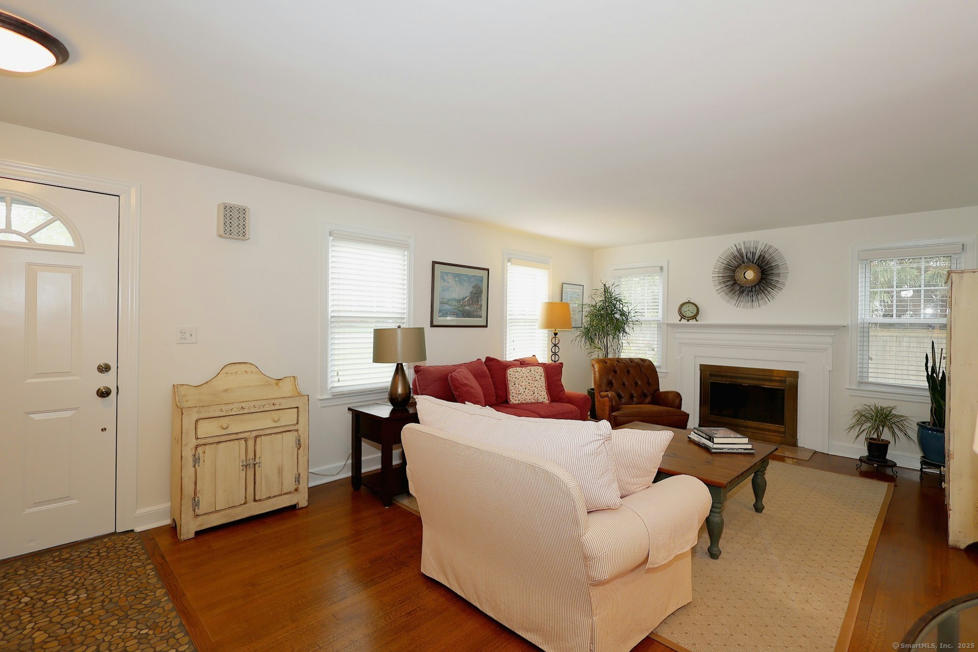 100 Overhill Road Fairfield, CT 06824 - Photo 5 of 40 a living room with furniture a fireplace and a table