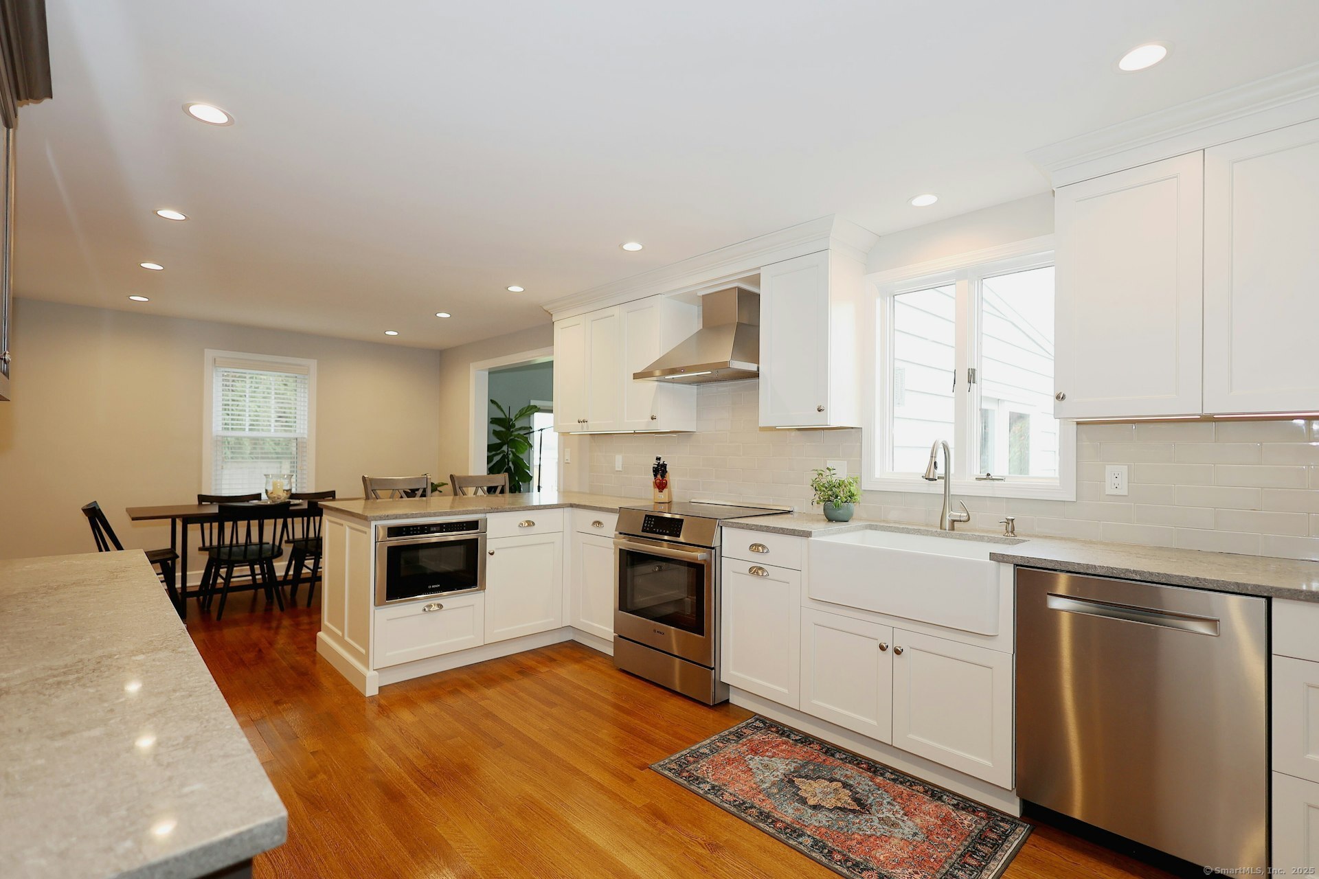 100 Overhill Road Fairfield, CT 06824 - Photo 8 of 40 a kitchen with white cabinets and appliances