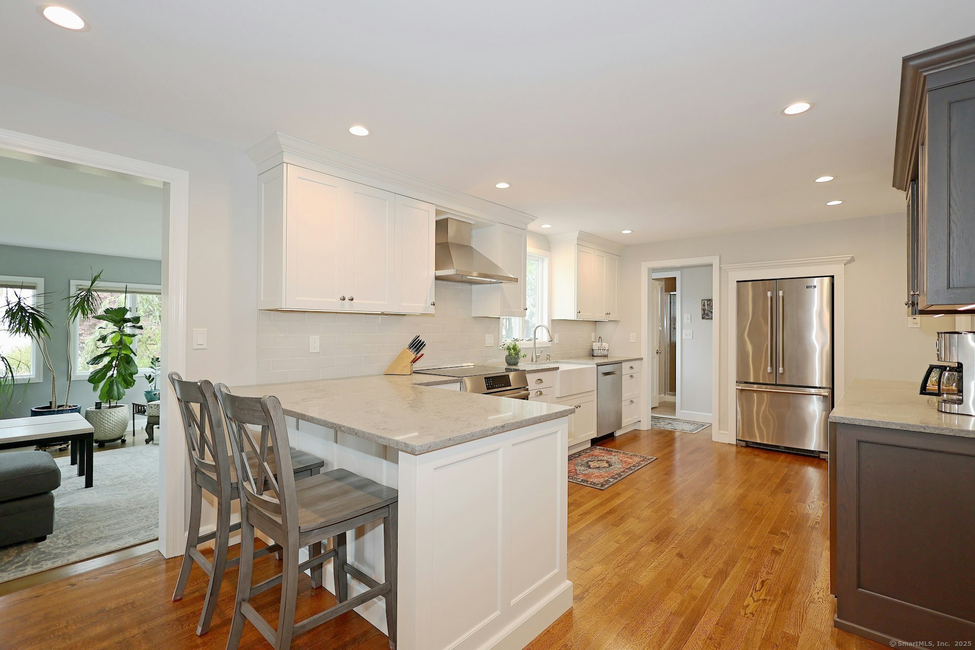 100 Overhill Road Fairfield, CT 06824 - Photo 9 of 40 a kitchen with a table chairs refrigerator and microwave