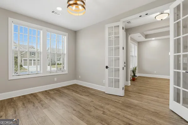 a view of a room with wooden floor and windows