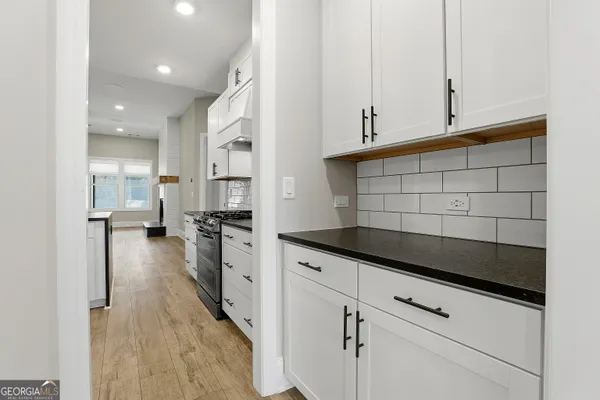 a view of a kitchen with a refrigerator and a window