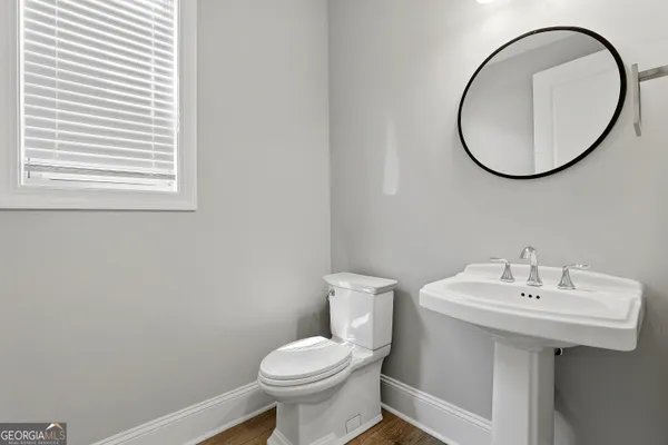 a kitchen with stainless steel appliances granite countertop a sink a stove and a wooden floors