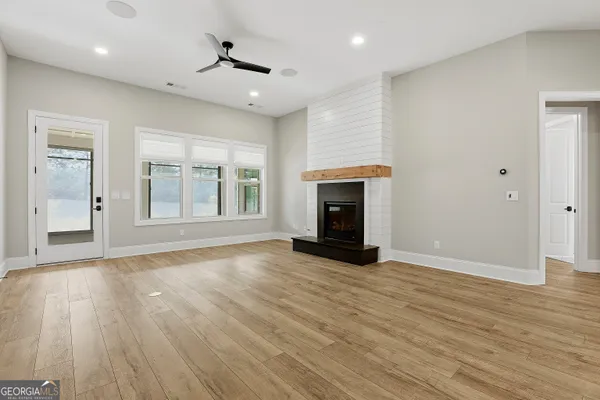 a kitchen with stainless steel appliances granite countertop a sink a stove and a refrigerator