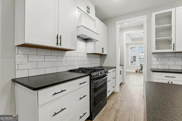 a view of empty room with wooden floor and window
