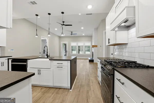a bathroom with a double vanity sink a mirror a shower and a bathtub