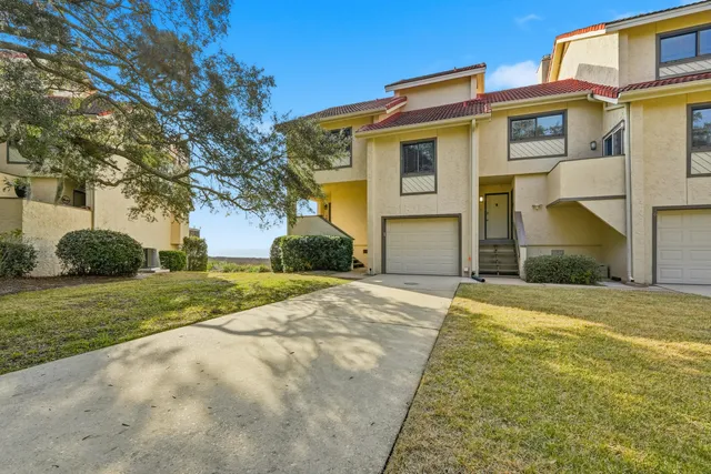 a bathroom with a granite countertop toilet sink mirror and vanity