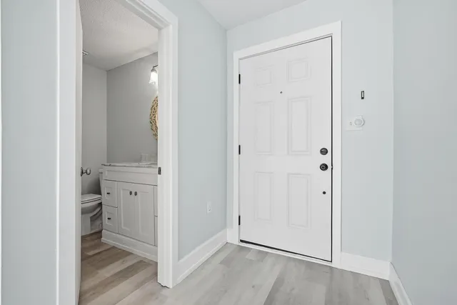 a view of a room with wooden floor and windows