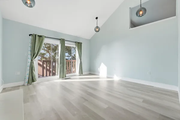 a view of a kitchen and wooden floor