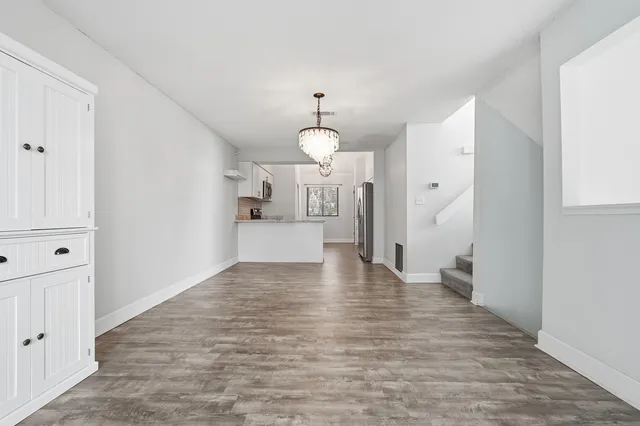 a view of kitchen with furniture and wooden floor