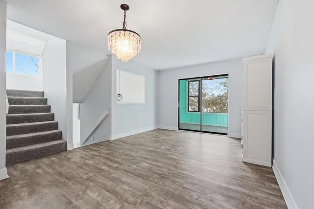 a large white kitchen with cabinets and stainless steel appliances