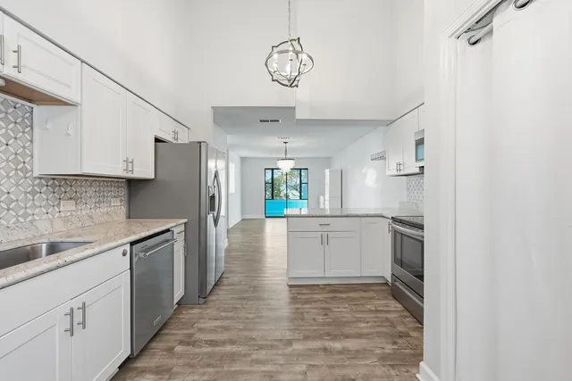 an empty room with windows and stairs