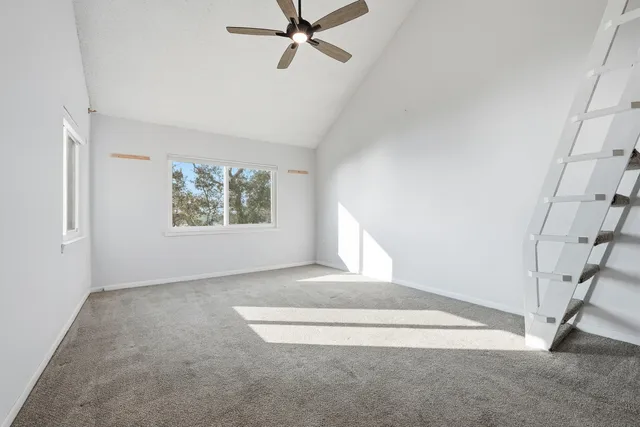 a view of a porch with furniture and a yard