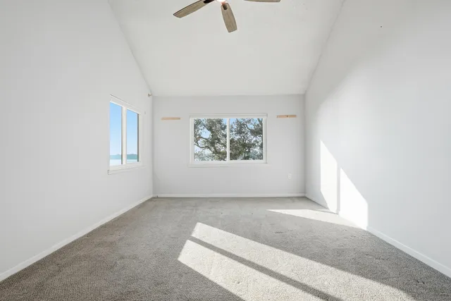an empty room with window and wooden floor