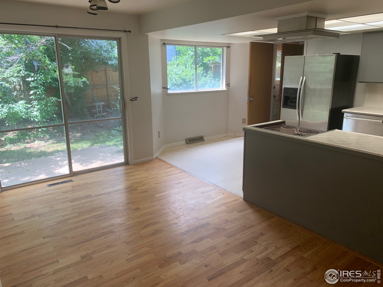 3310 Everett Drive Boulder, CO 80305 - Photo 6 of 17 an empty room with wooden floor and windows