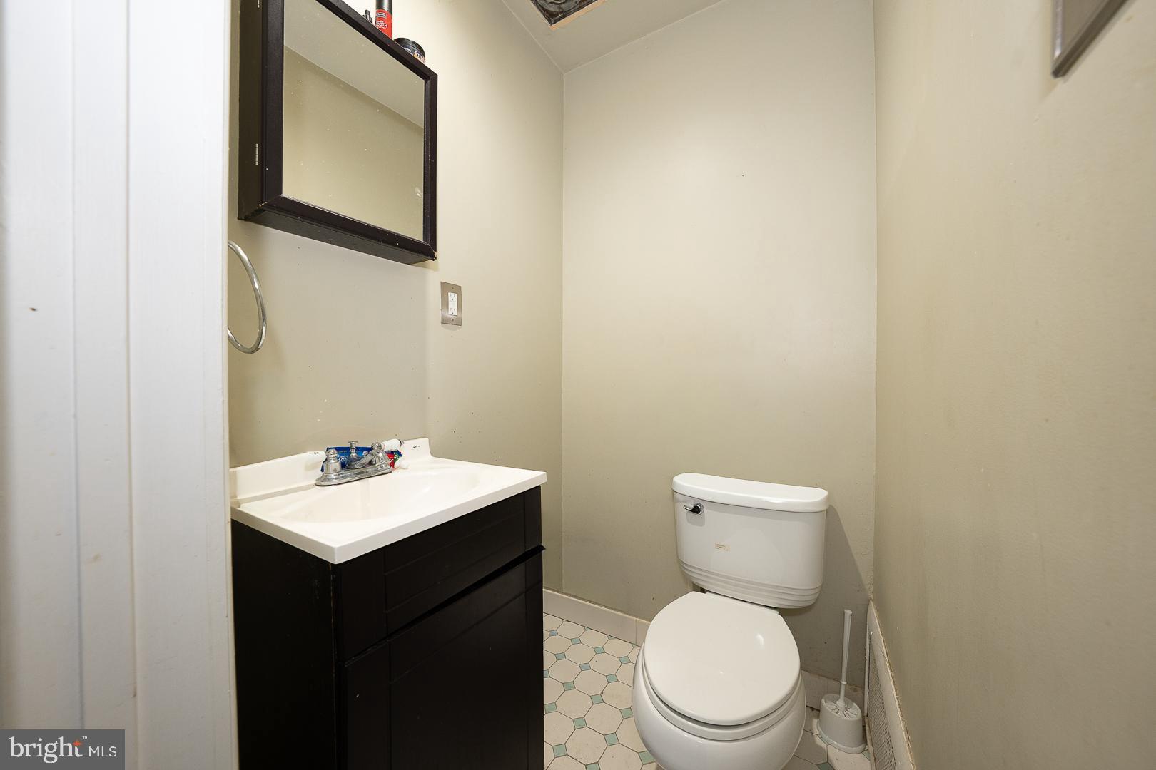 122 Crestview Road Upper Darby, PA 19082 - Photo 21 of 46 a bathroom with a toilet a sink and mirror