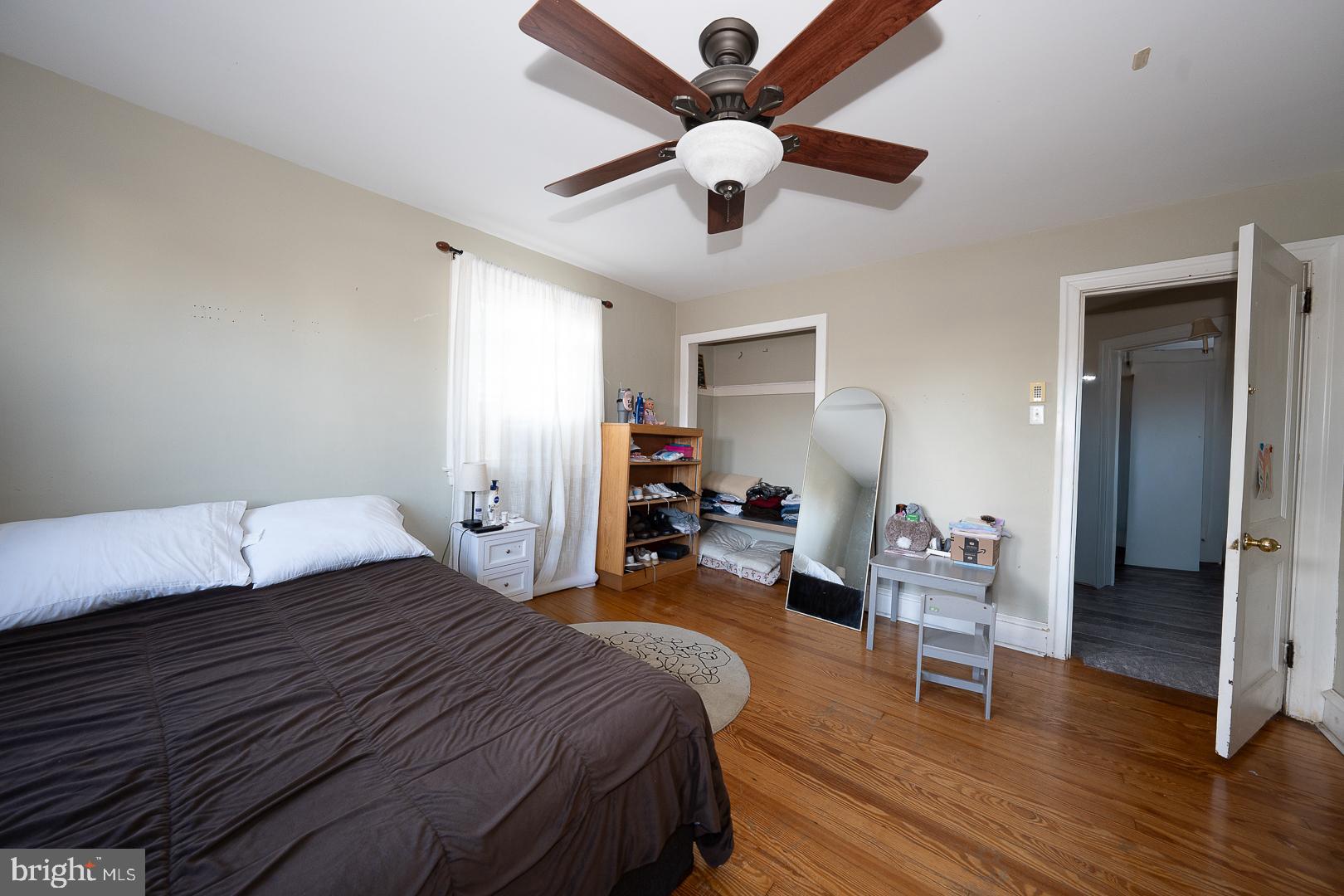 122 Crestview Road Upper Darby, PA 19082 - Photo 32 of 46 a bedroom with a bed and wooden floor