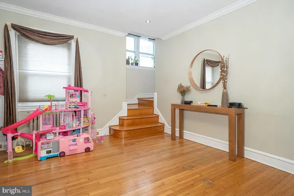 a bedroom with furniture and a wooden floor
