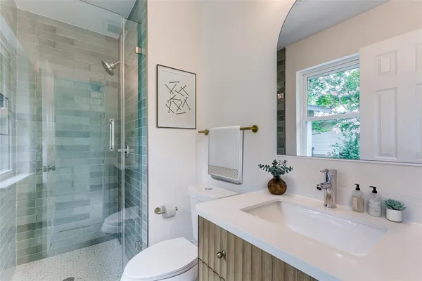 a bathroom with a sink toilet and shower