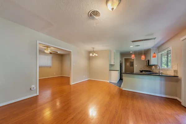 a view of a kitchen with a sink and a stove top oven