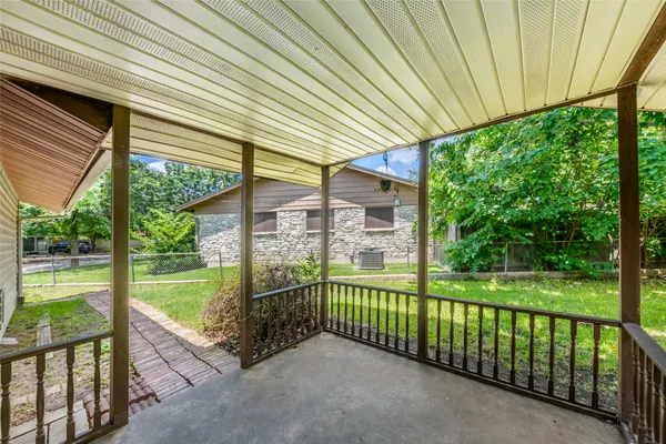 a view of a porch with a table and chairs